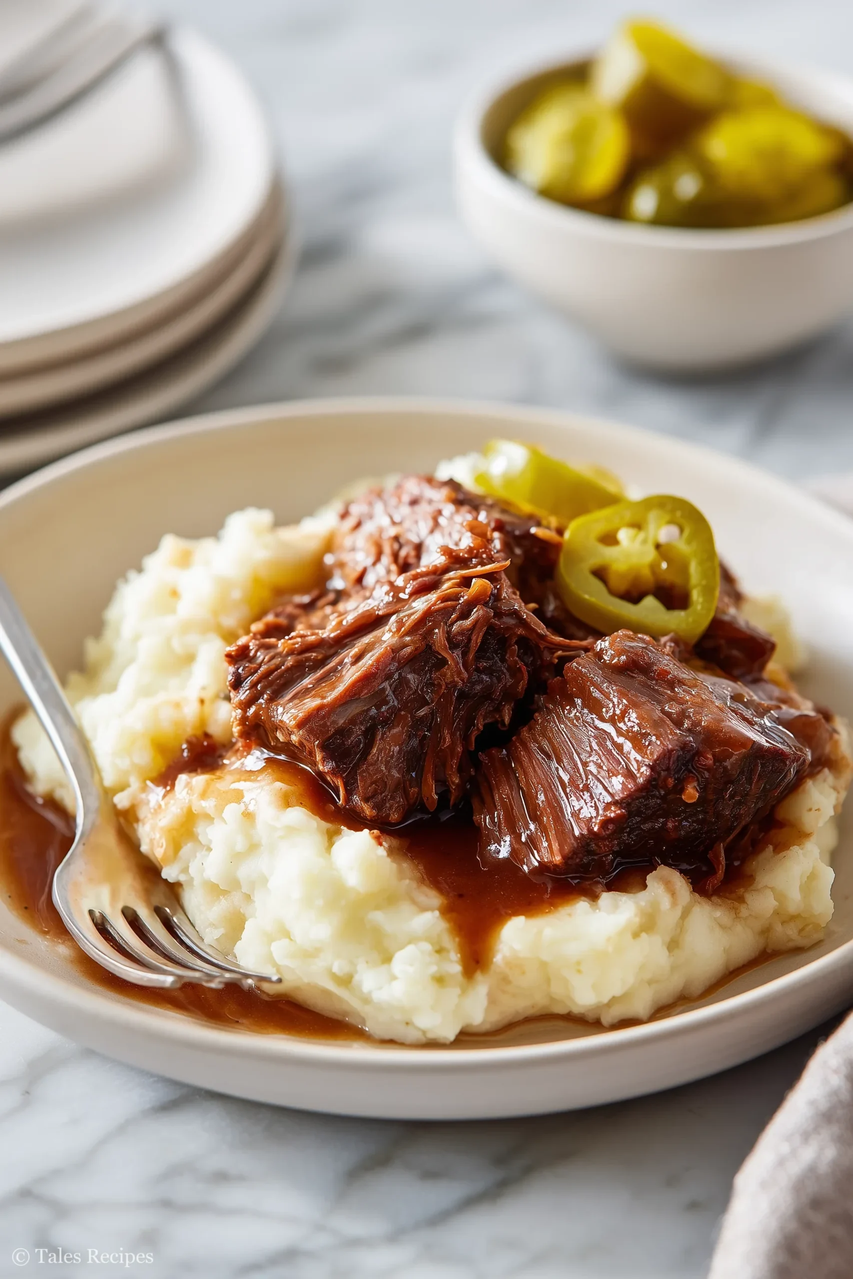 Mississippi pot roast plated with mashed potatoes and gravy for a family-friendly dinner